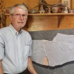 Dr. Ron Buta posing with a trackway consisting of three parts, all of which he found on different visits to the Crescent Valley Mine. These are primitive reptile footprints called Cincosaurus cobbi.